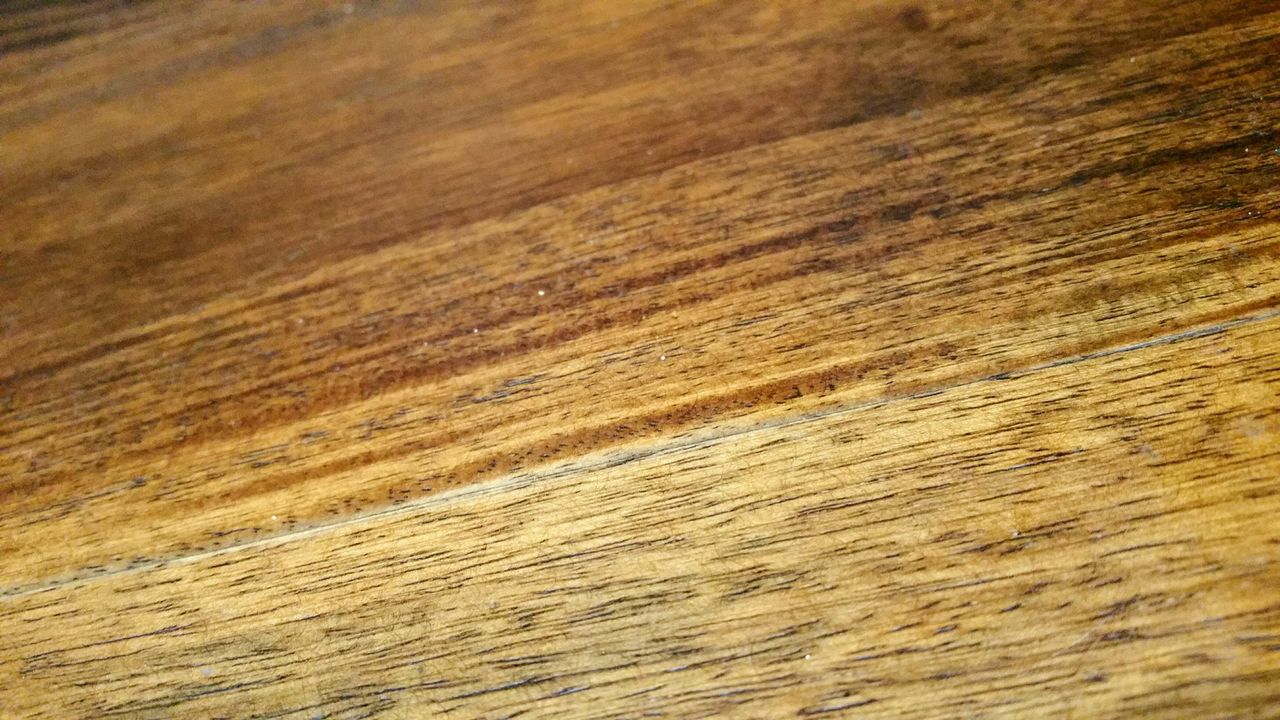 Detailed close-up of a textured wooden surface showcasing natural grains and patterns.
